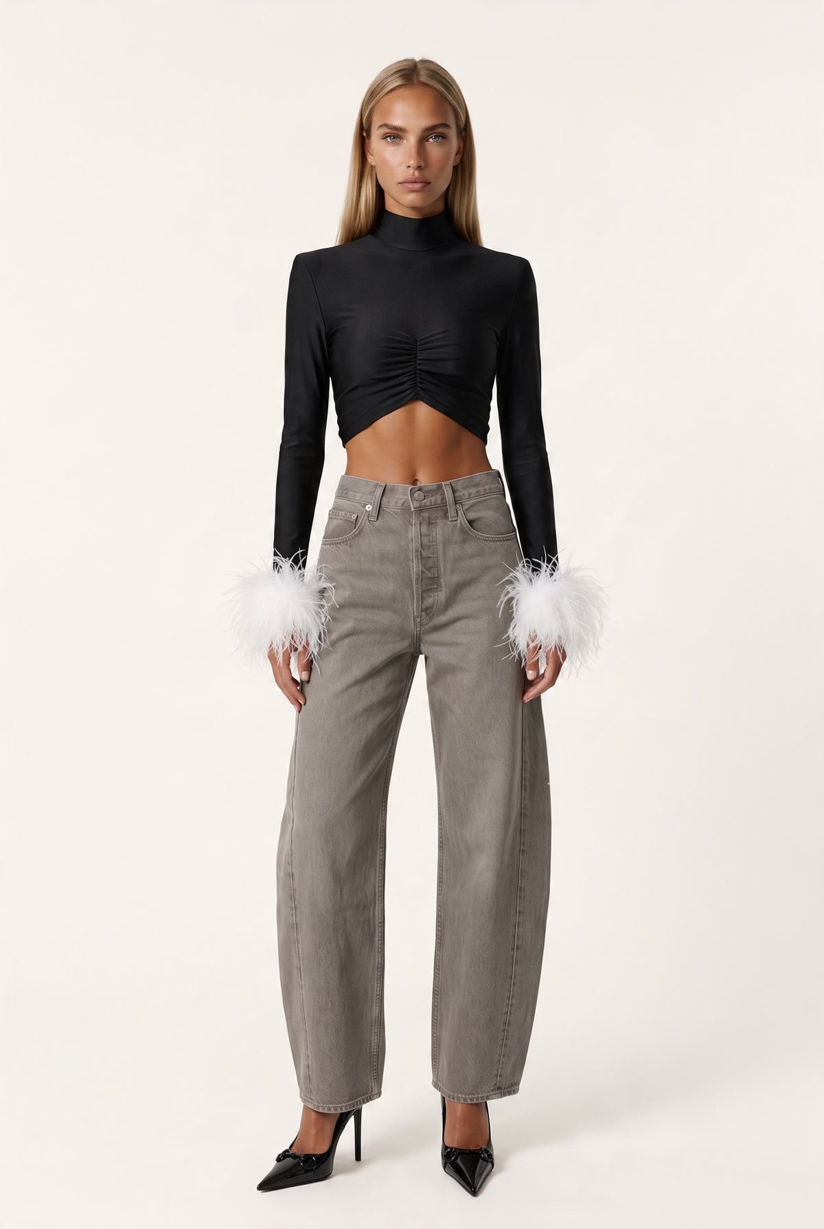 The Saint 54 fitted black long-sleeve top with polo neckline, front gathering, and detachable white ostrich feathers.