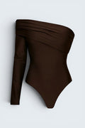 The Saint 54 brown one-shoulder long sleeve bodysuit with draped detailing and a sleek, stretchy finish.
