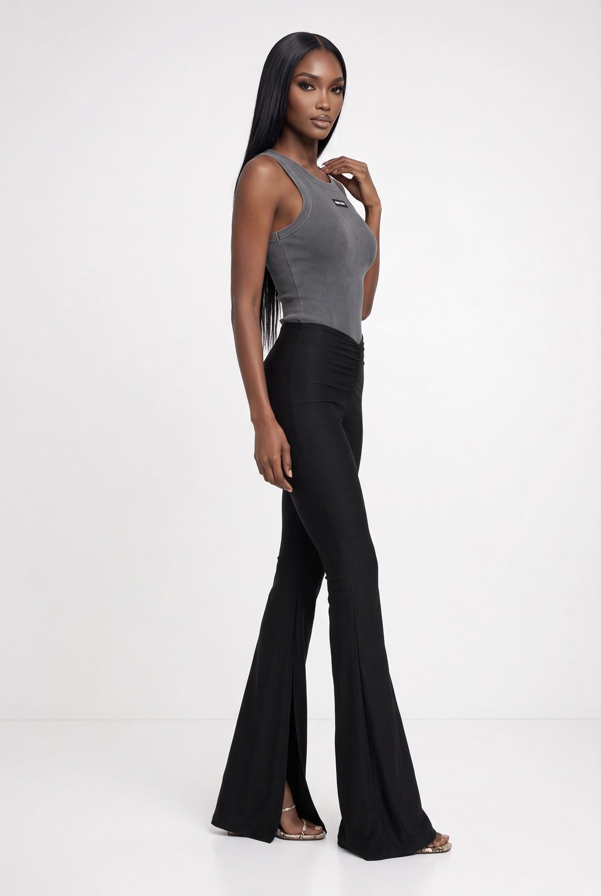 The Saint 54 set featuring a grey sleeveless fitted top and black high-waisted flared trousers with side slits