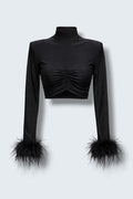 The Saint 54 Miss Rose black long-sleeve crop top featuring elegant ostrich feather cuffs on a model